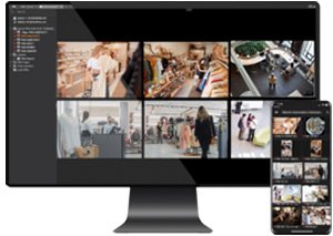 Desktop computer monitor and mobile phone displaying multi-camera security surveillance feeds simultaneously