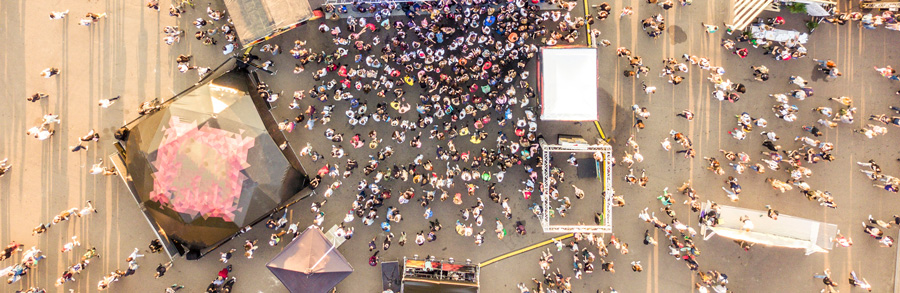 Surveillance camera aerial view of a large crowed public event and festival.