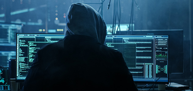 A hacker is analyzing data on Multiple Screens.