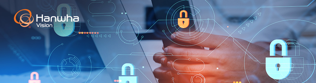 Concept image depicting locks in the foreground in front of a person typing on a laptop, representing the concept of cybersecurity.