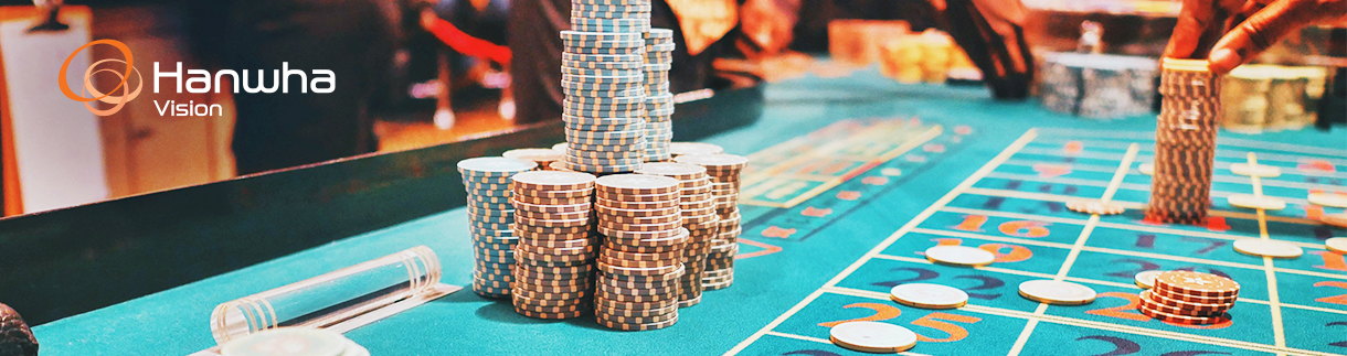 banner_1_casino_security poker chips stacked up on a poker table in a casino